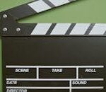 PROYECTOS A classic film clapperboard on a green surface, essential for movie scenes.